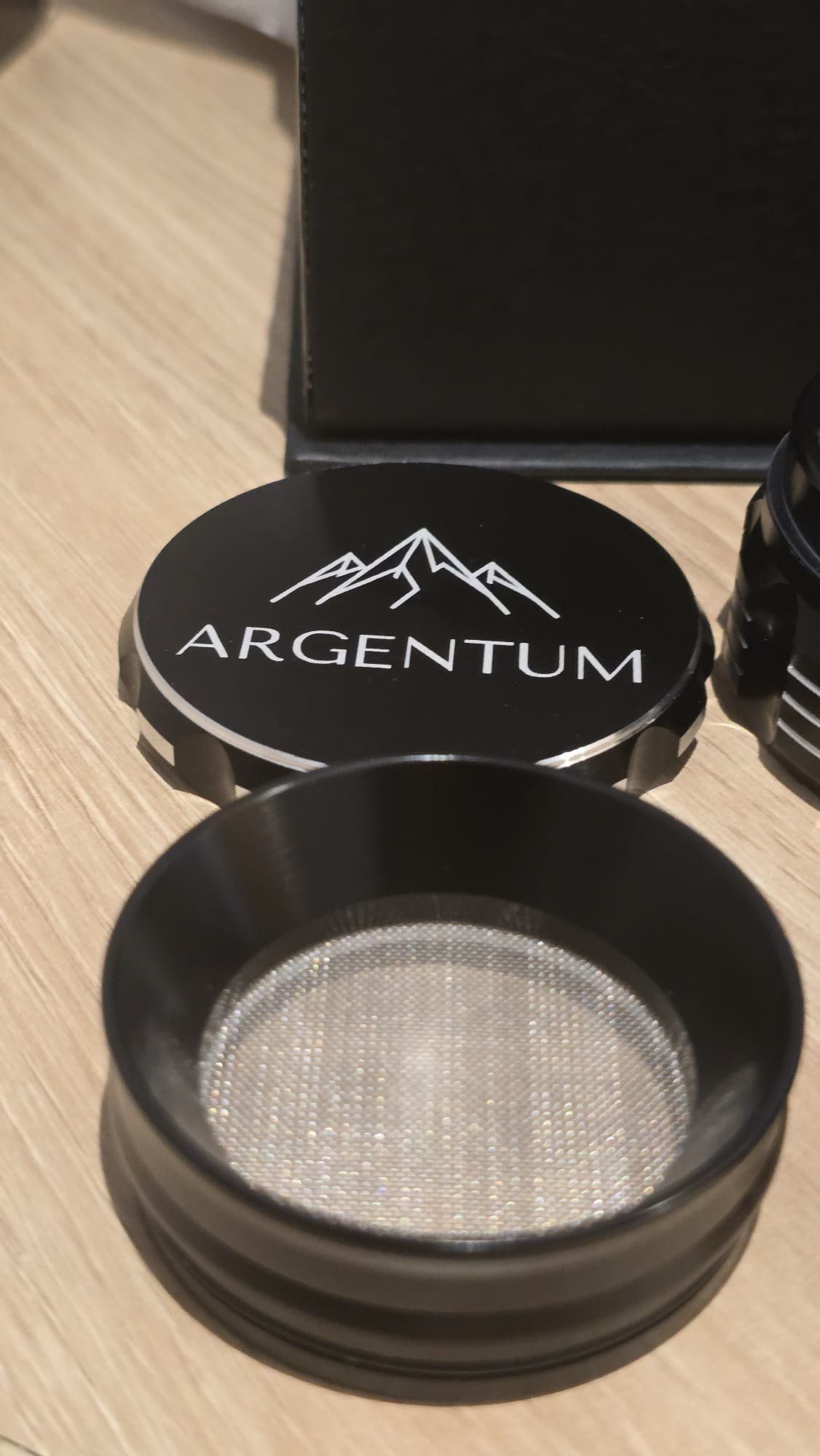 The removable mesh screen lifted out of the bottom chamber